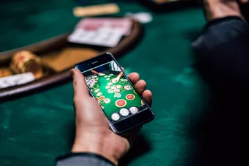 A glowing roulette wheel with cascading chips, symbolizing the engaging live and instant-win games available on K677.